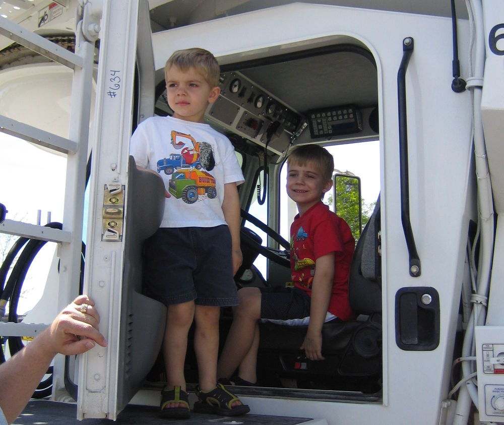 Photo of two boys sitting in one of our delivery trucks.
